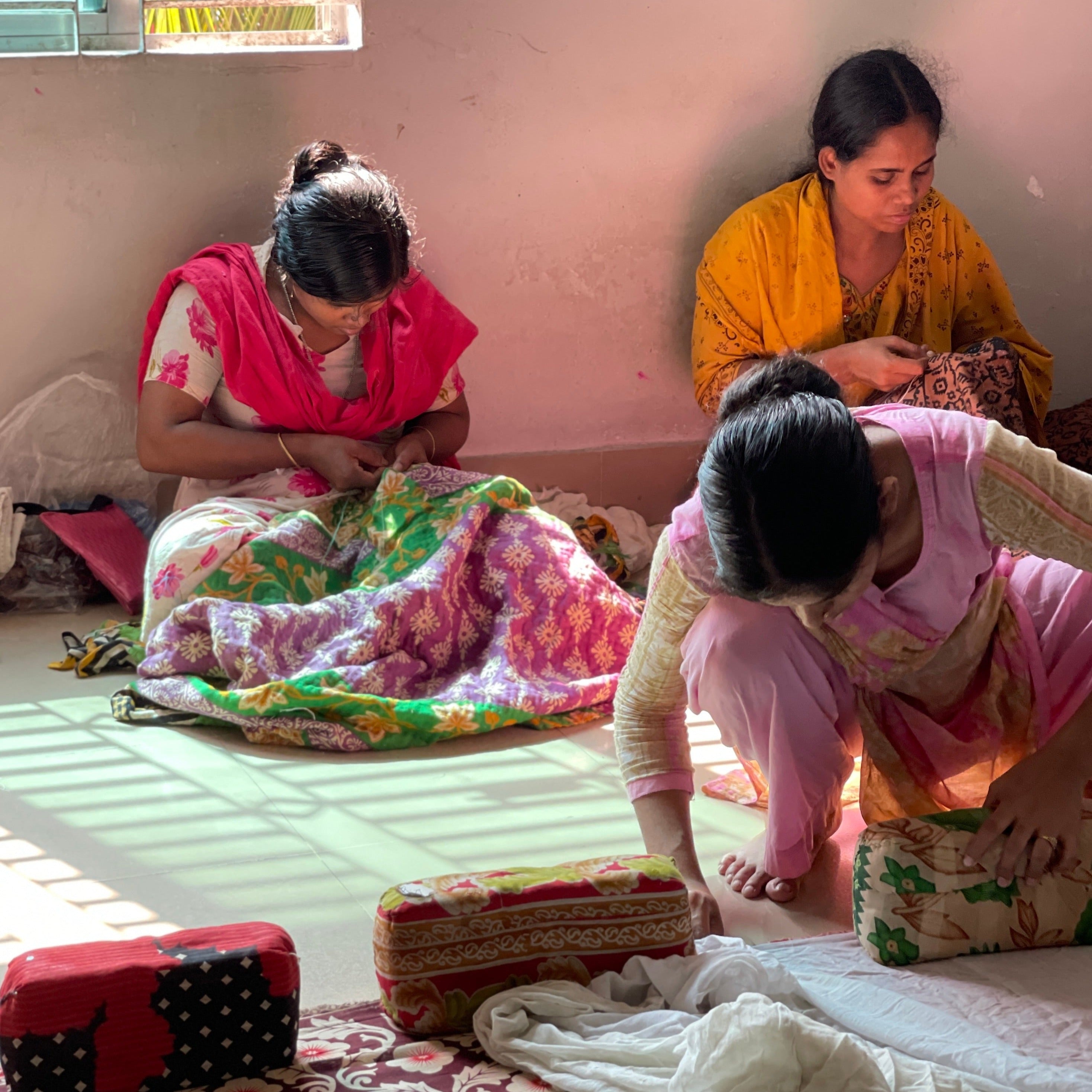 Des femmes artisans en train de fabriquer des kanthas avec des saris anciennes